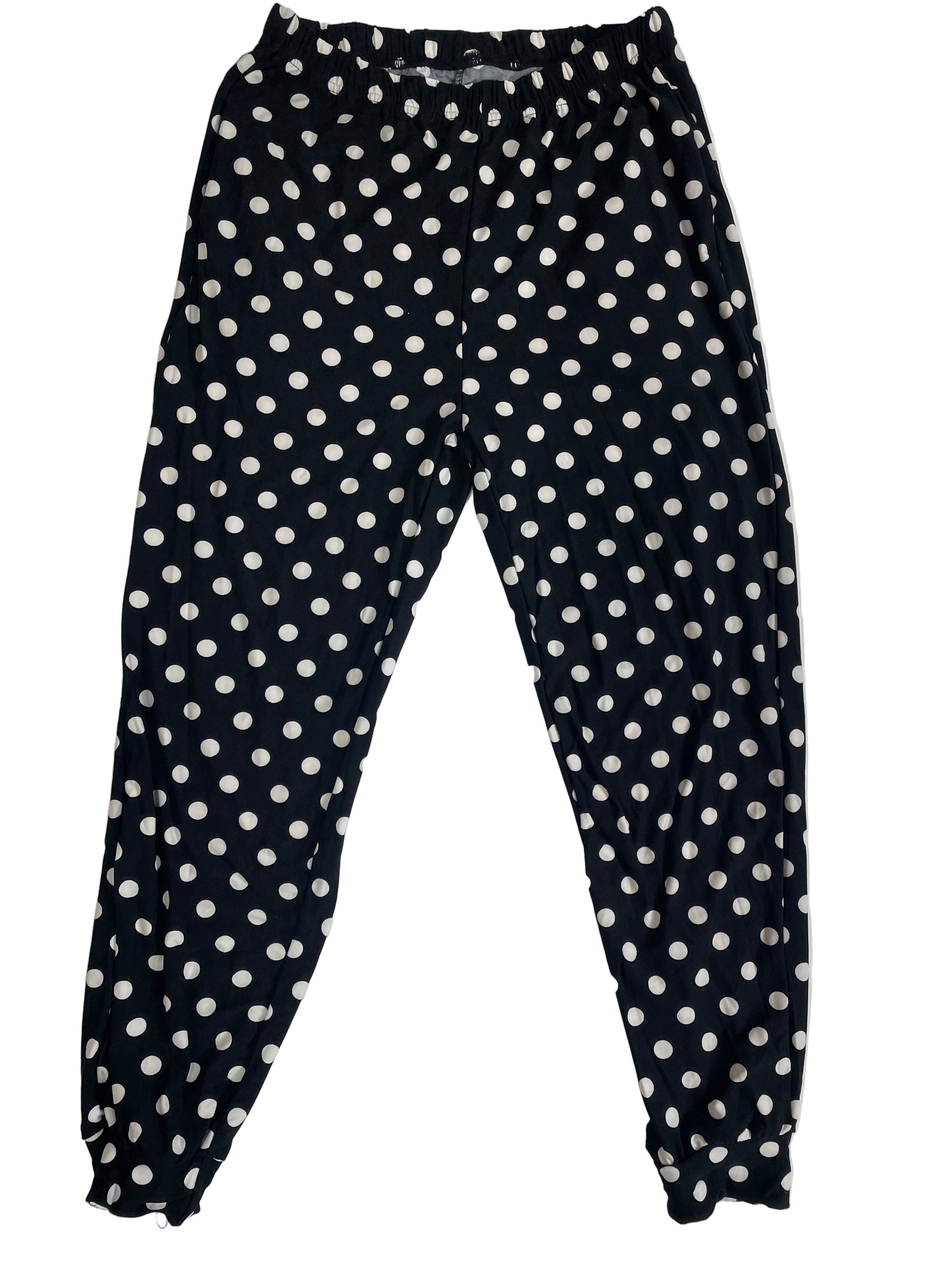 Black pants with white polka dots on a white background